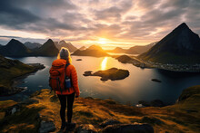 Back View Of Tourist Standing On Top Of A Rock And Enjoying Fascinating View With Mountains And Lakes Around. Concept Of Adventure In Scandinavian Countries