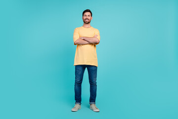 Poster - Full body photo of young confident man in yellow t shirt and jeans crossed arms when see his girlfriend isolated on blue color background