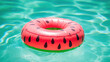 An inflatable circle in the color of a Watermelon on the surface of the pool