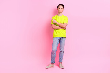 Poster - Full length photo of cheerful cool guy wear green t-shirt pointing finger empty space isolated pink color background