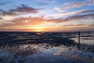 Wall Mural - Low tide and sunset on Hauteville-sur-Mer beach.Cotentin coast