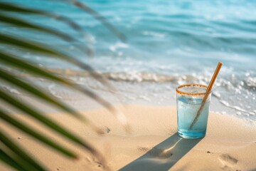 Wall Mural - Tropical fresh Blue Curacao Cocktail near swimming pool on seacoast and ocean background. Copy space. Close up.