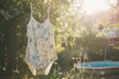 swimsuit with floral patterns drying in a sunny garden