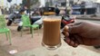 © Joseph - Tea served in a cup closeup with selective focus and blur. Indian famous hot chai served in a glass cup.