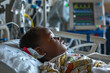 © ty - african boy 5 years lies in a hospital ward, connected to life support equipment, monitors