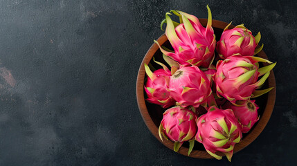 Wall Mural - top view dragon fruit on the wooden bowl and black table