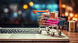 © anandart - Online shopping concept with cart full of boxes on top of laptop computer