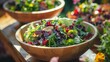 Hearty Wooden Bowl of Mixed Leafy Greens. A hearty bowl of mixed leafy greens, with a diverse mix of colors and textures, served in a rustic wooden bowl ready for a healthy meal.