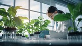 Fototapeta  - A biotechnologist woman studies plant leaves for the presence of diseases, conducts experiments with chemicals and fertilizers in a scientific research laboratory.