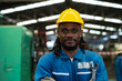 © KANGWANS - Portrait of a black male mechanical engineer working at a metal lathe factory. Worker working with machine lathe African American workers.