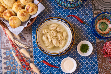 Wall Mural - dumplings in broth on an oriental table, background