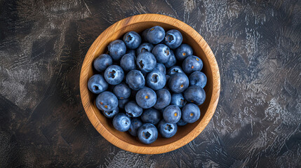 Wall Mural - top view blueberries on wooden bowl with dark background