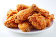 © Rangga Bimantara - pile of crispy fried chicken on a white plate isolated on white background