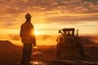 worker and construction machinery, silhouette of a person at sunset