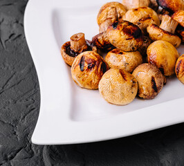 Wall Mural - Baked mushrooms in plate on a stone table