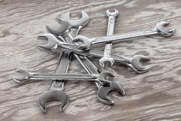 Spanners. Many wrenches. Industrial background. Set of wrench tool equipment on wooden background.