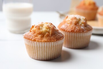 Delicious sweet muffins on white table, closeup