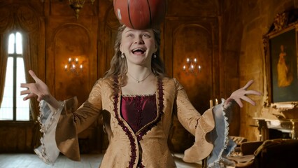 Wall Mural - Woman in ancient outfit on background of historic interior. Woman in renaissance style dress tossing a basketball.