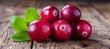 Close up of ripe red cranberries with textured detail and leaves in vivid, vibrant colors