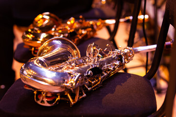 Wall Mural -  Saxophone lying on a chair on stage close-up