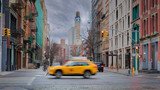 Fototapeta Krajobraz - Yellow taxi crossing Broadway Street in NOHO, NYC