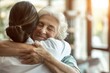 © Hannes - Elderly Woman Hugging Nurse Warmly in Sunlit Room Showing Gratitude and Affection
