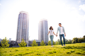 Poster - Photo of young lovely couple idyllic young happy students family walking around their outdoor territory near modern residential complex