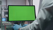 © stockbusters - Gloves hands typing keyboard green screen computer in laboratory close up.