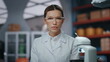 © stockbusters - Confident medical scientist posing in advanced laboratory in glasses close up.