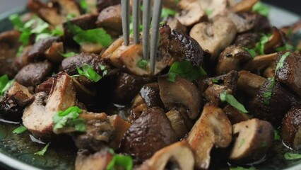 Wall Mural - Eating Delicious fried mushrooms with herbs and parsley.