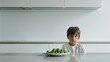 a sulking child seated in front of a plate of vegetables on a modern kitchen table, portraying the challenges of mealtime struggles and healthy eating habits in a contemporary setting.