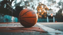 A Basketball Sitting On The Ground In Front Of A Basketball Hoop