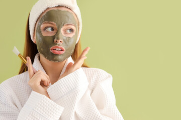 Wall Mural - Young woman with applied facial mask on green background, closeup