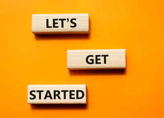 Wall Mural - Lets get started symbol. Concept words Lets get started on wooden blocks. Beautiful orange background. Business and Lets get started concept. Copy space.