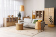 © Pixel-Shot - Interior of cozy living room with grey sofa, wooden table and lamps