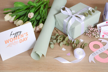 Sticker - Beautiful gift box, packing materials, flowers and greeting card for International Women's Day on wooden background