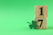 canvas print picture - St. Patrick's day - 17th of March. Block calendar and decorative clover leaf on green background. Space for text