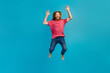 © deagreez - Full body portrait of astonished active person jumping raise arms empty space isolated on blue color background