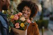A woman's radiant smile blooms as she stands outdoors, holding a meticulously arranged bouquet of fresh and artificial flowers in a stunning display of floristry