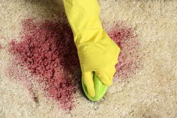 Sticker - Woman removing stain from beige carpet, top view