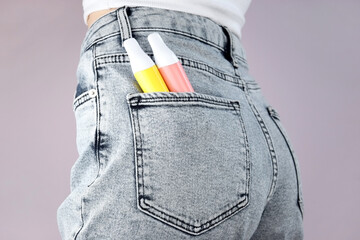 Wall Mural - A set of multi-color disposable electronic cigarettes in a jeans pocket.