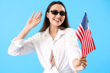 Poster - Young woman with USA flag on blue background