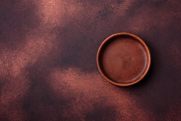 Empty ceramic round plate on dark textured concrete background