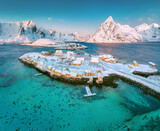 Fototapeta Na ścianę - Lofoten islands beautiful nature landscape in Norway and fishing town with scenic yellow rorbu houses of Sakrisoy, Reine