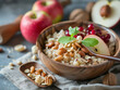 Oatmeal with apples, nuts and honey in a bowl on a wooden background.