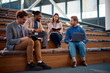 © Drazen - Happy black businessman talking to his colleagues while participation in education event at convention center.