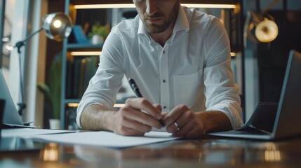 Poster - A focused man, dressed in professional attire, intently types on his laptop indoors, diligently working on his job