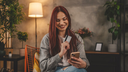 young woman caucasian female hold credit card online shopping at home