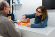 © Egoitz - Audiologist showing ear model to patient and explaining his problem