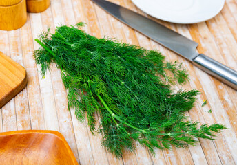 Wall Mural - Freshly harvested organic green dill on a wooden background